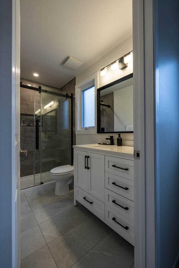 3 piece bathroom white vanity with large tile floor