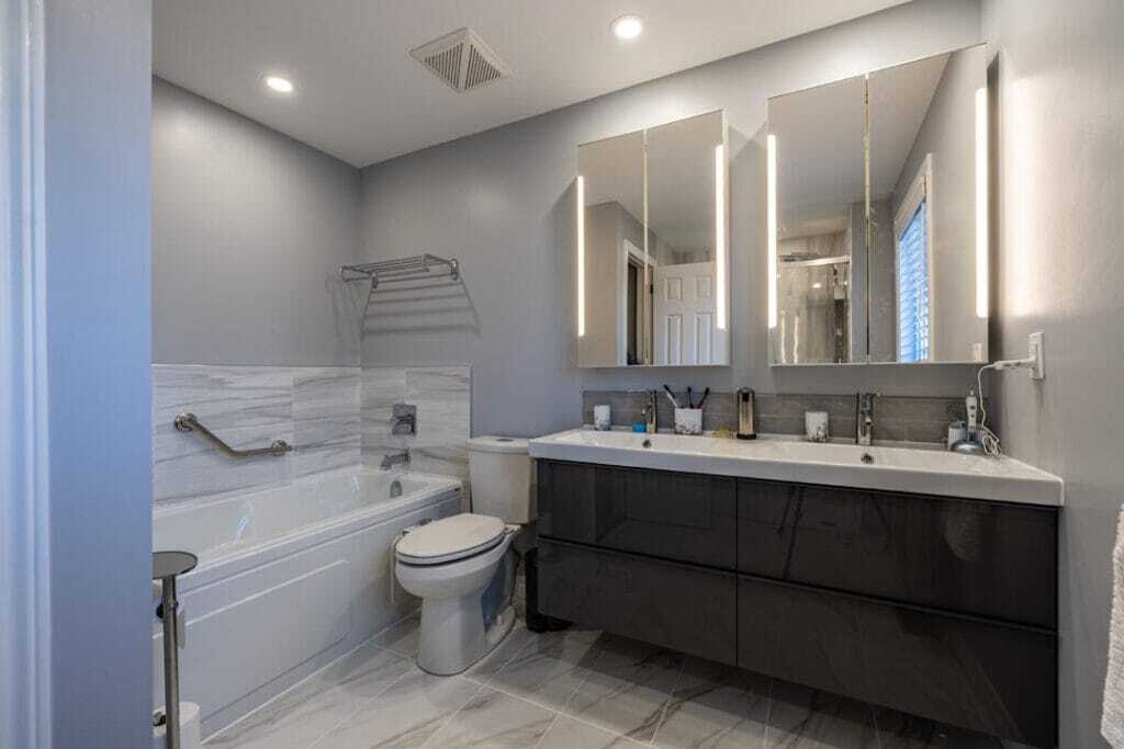 floating vanity with two basin counter top with attached bath tub