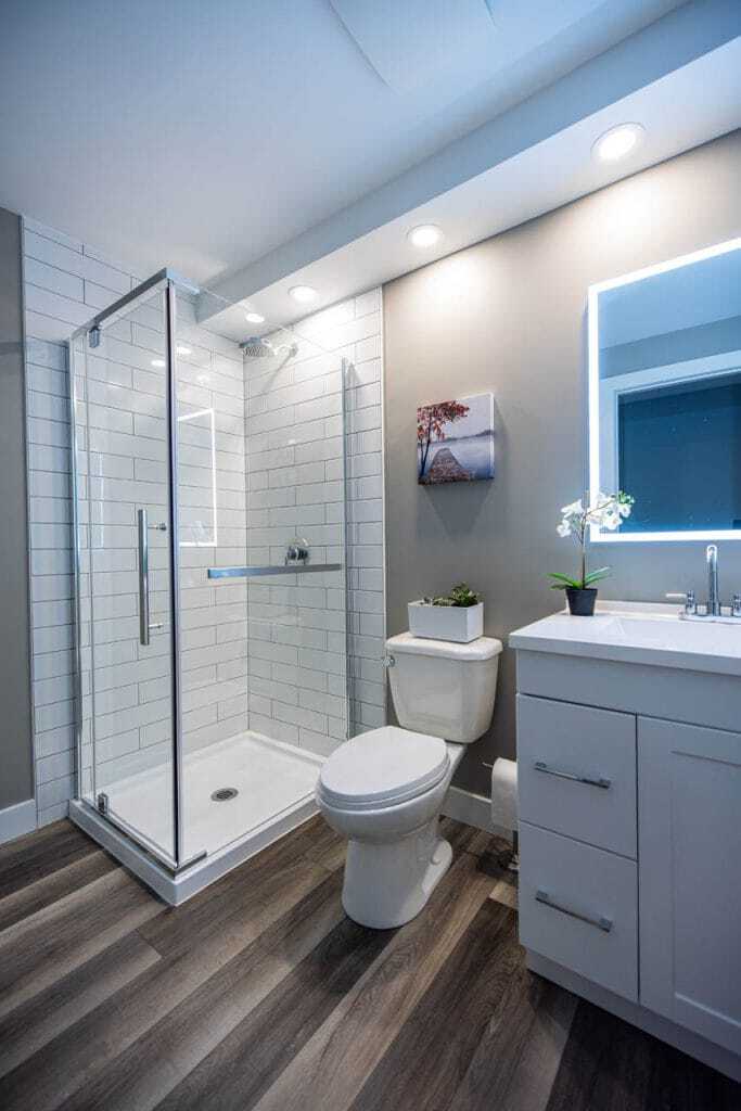 shower with sliding door handle and toilet with vanity