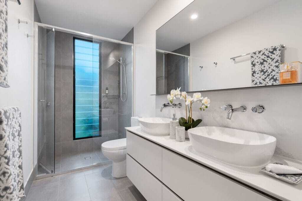 shower glass enclosure with vessel sing on top of vanity