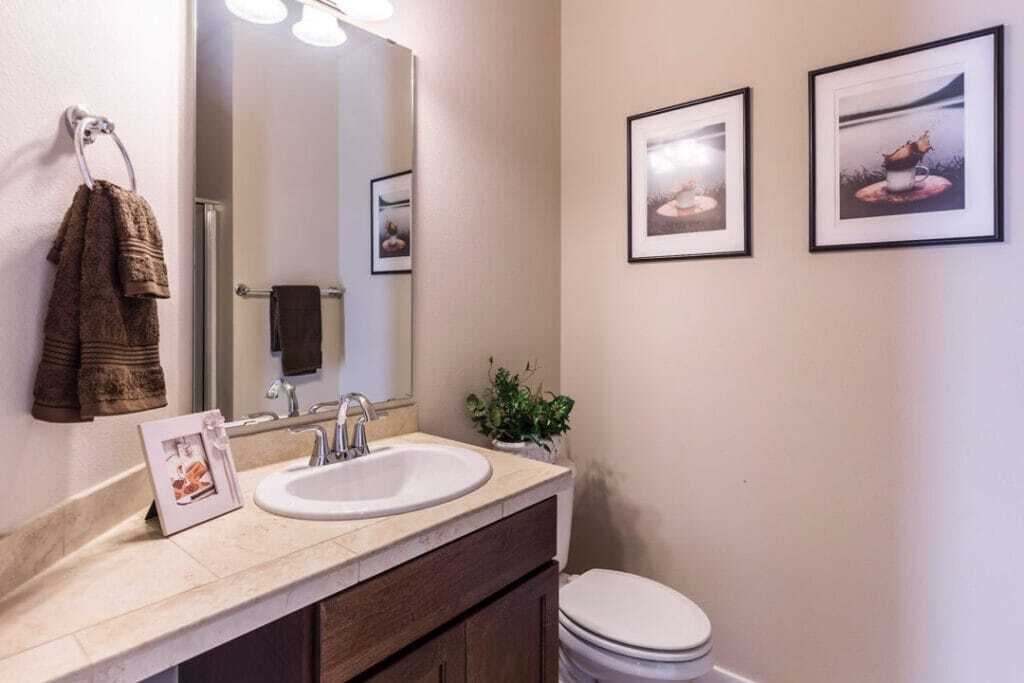 vanity with tiles counter top with vertical mirror