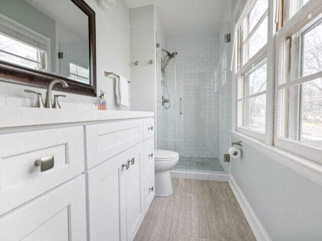 wood countertop with white vanity and matching subway tiles