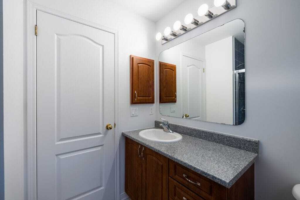 wooden vanity with marble counter top