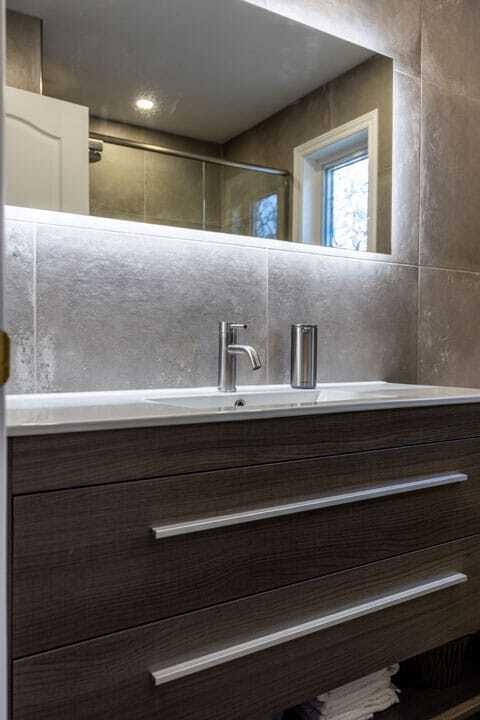 brown vanity grey tiles LED mirror