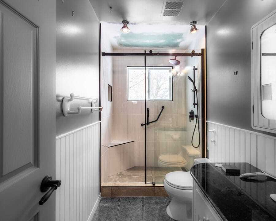 marble countertop with sliding shower door and lightning
