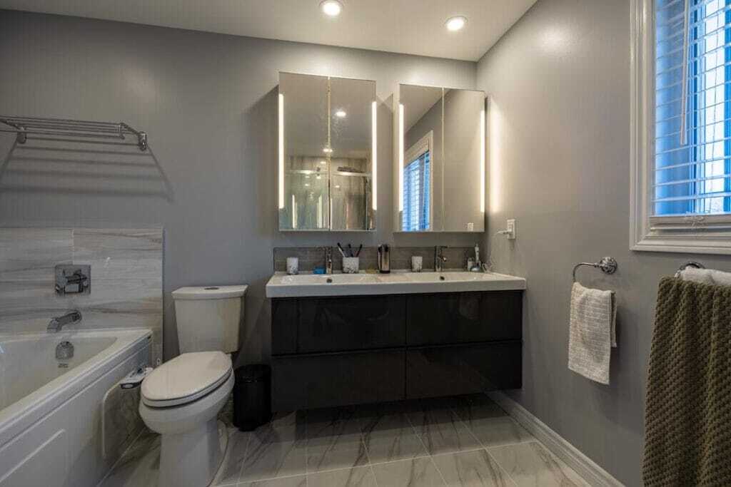 tiled floor and vanity with LED mirrors