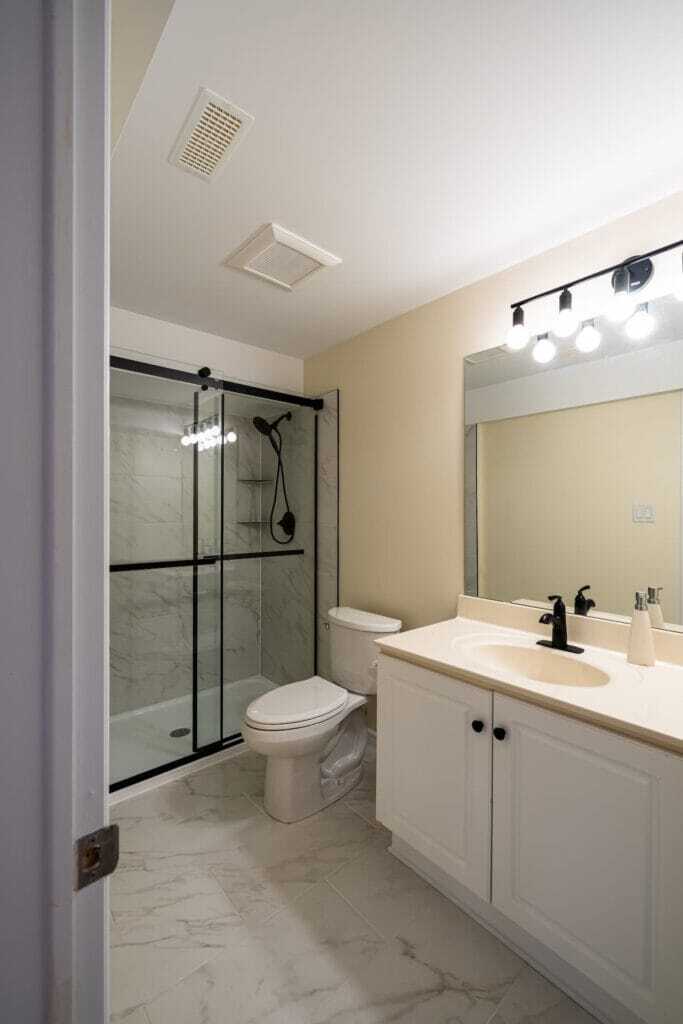 acrylic base with tiled walls and white vanity