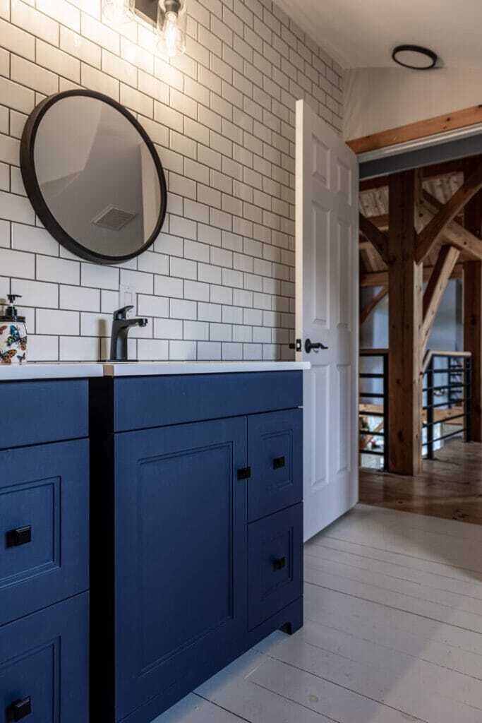 blue vanity over subway tile wall in bathroom