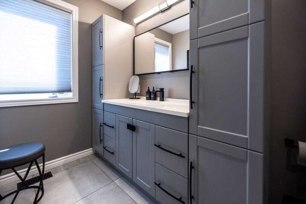 grey vanity with grey tiles