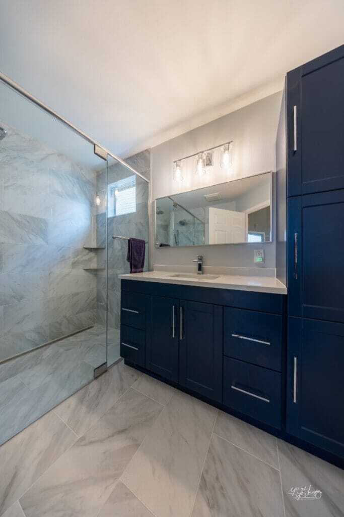 White renovated bathroom with blue vanity